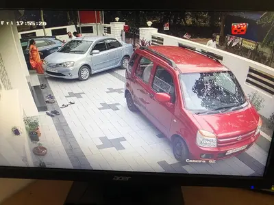 a tv screen with a picture of two cars at Sannidhi Home stay in Guruvāyūr