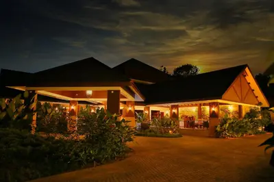 a house lit up at night with lights at Morickap Resort in Vythiri