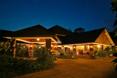 a house with lights on it at night at Morickap Resort in Vythiri