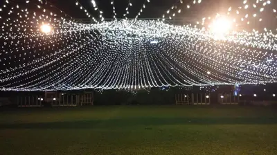a group of white lights hanging from a tent at Hotel Merlin International in Trichūr