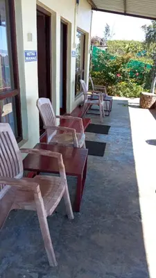 a row of chairs and tables on a patio at The Views - True Baduaga Living in Ooty