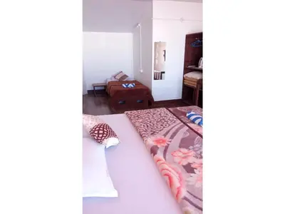 a bedroom with a bed and a couch in a room at The Views - True Baduaga Living in Ooty