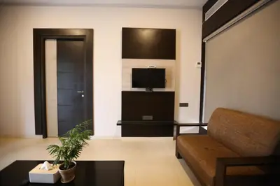 a living room with a couch and a tv at D Wayfarer Inn Resort in Erode