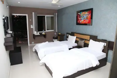 a bedroom with three beds and a window at ALSHIFA TBG RESIDENCY in Perintalmanna