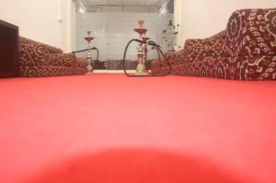 a room with two couches and a red carpet at ALSHIFA TBG RESIDENCY in Perintalmanna