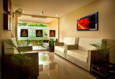 a living room with a couch and a window at ALSHIFA TBG RESIDENCY in Perintalmanna
