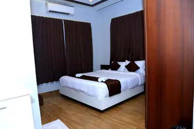 a bedroom with a bed and a large mirror at MAZUS INN in Vythiri