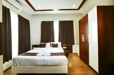 a bedroom with a bed with a flower on it at MAZUS INN in Vythiri