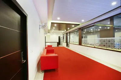 a hallway with a red bench in a building at MAZUS INN in Vythiri