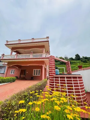 a house with yellow flowers in front of it at Chill Inn - Families Only in Ooty