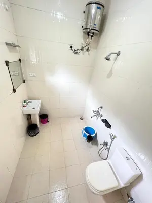 a bathroom with a toilet and a sink at Chill Inn - Families Only in Ooty