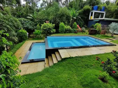 a swimming pool in the yard of a house at Le Eden Premium Wayanad Pool Resort in Sultan Bathery