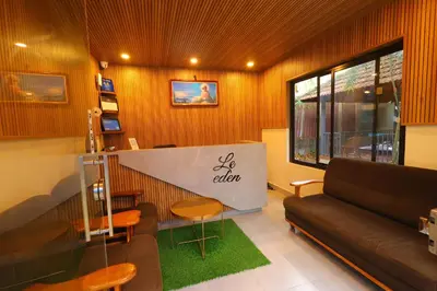a living room with a couch and a table at Le Eden Premium Wayanad Pool Resort in Sultan Bathery