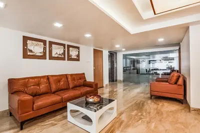 a living room with a couch and a table at Park Avenue Suites in Coimbatore