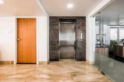 a hallway with a elevator and a door at Park Avenue Suites in Coimbatore
