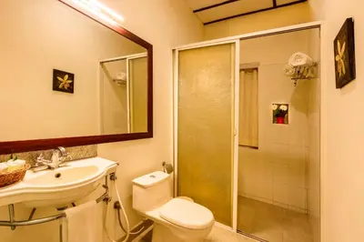 a bathroom with a toilet and a sink and a shower at Teanest by Nature Resorts and Stays in Coonoor