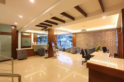 an office with a lobby with desks and chairs at Park Residency Airport Road in Kozhikode