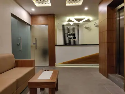 a living room with a couch and a table at Town Hub in Valāncheri