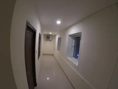 a hallway with a door and a window in a building at Town Hub in Valāncheri