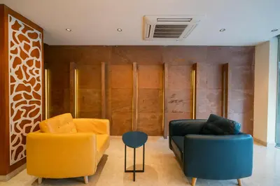 a living room with two chairs and a couch at JK HOTELS in Coimbatore
