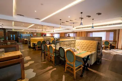 a restaurant with tables and chairs in a room at JK HOTELS in Coimbatore