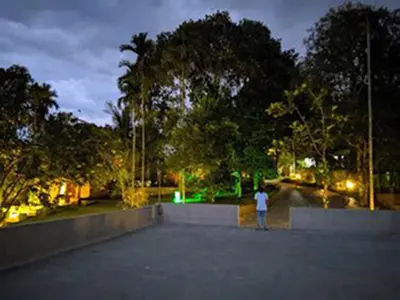 a person riding a skateboard in a skate park at night at Indeevara Luxury Resort and Spa, Wayanad in Vythiri