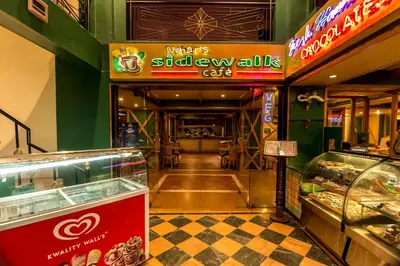 a restaurant with a sign for a bakery at Hotel Nahar Nilgiris in Ooty
