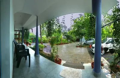 a view of a garden from the inside of a house at Monsoon Apartments in Kannur