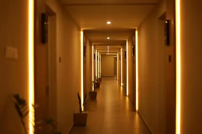 a hallway with a row of halls with lights at Noor jehan's Grand Noor in Palakkad