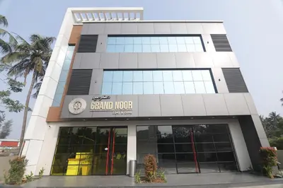 a building with a sign that reads sandlords at Noor jehan's Grand Noor in Palakkad