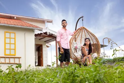 a man and a woman standing in front of a house at The Realm in Coonoor