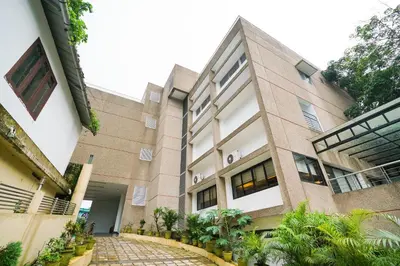 a building with a walkway in front of it at Townhouse Mookkannoor Tourist Home in Cochin