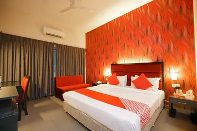 a bedroom with a bed and a red wall at Townhouse Mookkannoor Tourist Home in Cochin