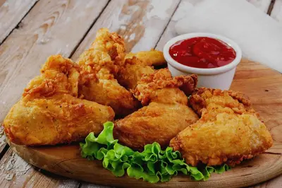 a plate of fried food with dipping sauce on a table at Townhouse Mookkannoor Tourist Home in Cochin