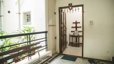 an open door to a balcony with a mirror at Homestay for Women in Coimbatore