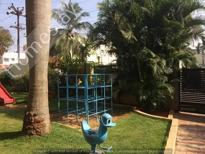 a playground in a park with a blue structure at Homestay for Women in Coimbatore