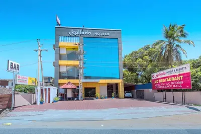 a building with a palm tree in front of it at Kallada Hotels and Resorts in Trichūr