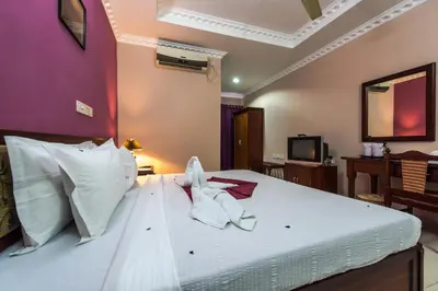 a hotel room with a bed with towels on it at Kallada Hotels and Resorts in Trichūr