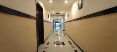 a hallway of a building with a long aisle at Hotel Jyothis Regency in Palakkad