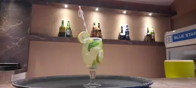 a drink in a martini glass on a table at Hotel Jyothis Regency in Palakkad