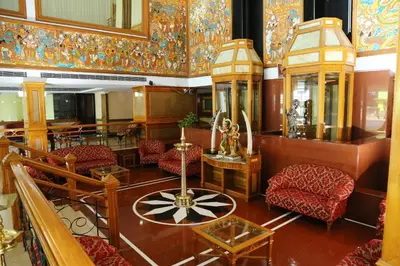 a living room with colorful walls and furniture at Mayura Residency in Guruvāyūr