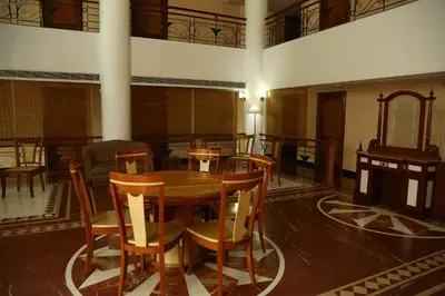 a dining room with a table and chairs at Mayura Residency in Guruvāyūr