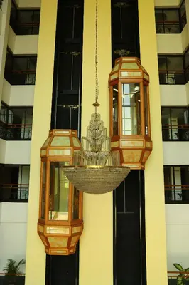 a chandelier hanging from the side of a building at Mayura Residency in Guruvāyūr