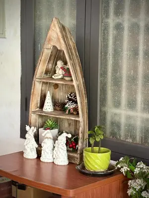 a shelf with two cats figurines on a table at Gloria Homestay ,Thrissur - Pooram Bookings open Apr 25-27 in Trichūr