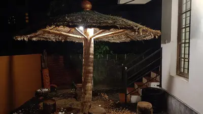 a large umbrella with a light on top of it at Swasthigriha's Beach Homestay, Cherai in Cherai Beach