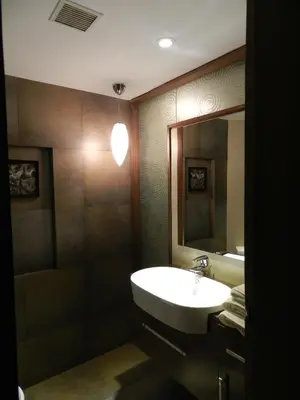 a bathroom with a sink and a mirror at Sinclairs Retreat Ooty in Ooty