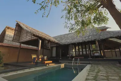 a house with a pool in front of it at SpiceTree Chinnar in Dhali