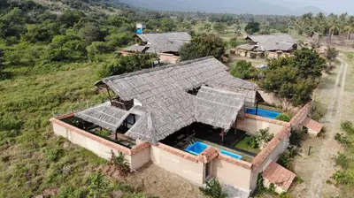 an overhead view of a house with a large roof at SpiceTree Chinnar in Dhali