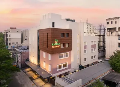 a building with a sign on the side of it at Rathna Residency in Erode