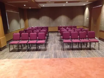 a row of purple chairs in a room at Rathna Residency in Erode